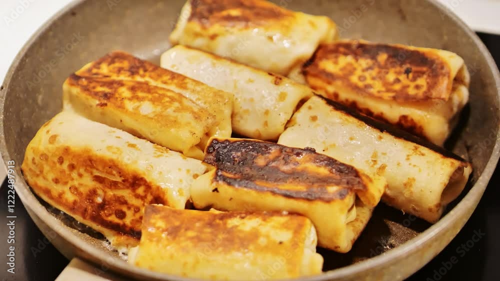 Blini pancakes cooking in frying pan with a glass lid on a stove - kitchen vibes Blini pancakes cooking in frying pan with a glass lid on a stove - kitchen vibes
