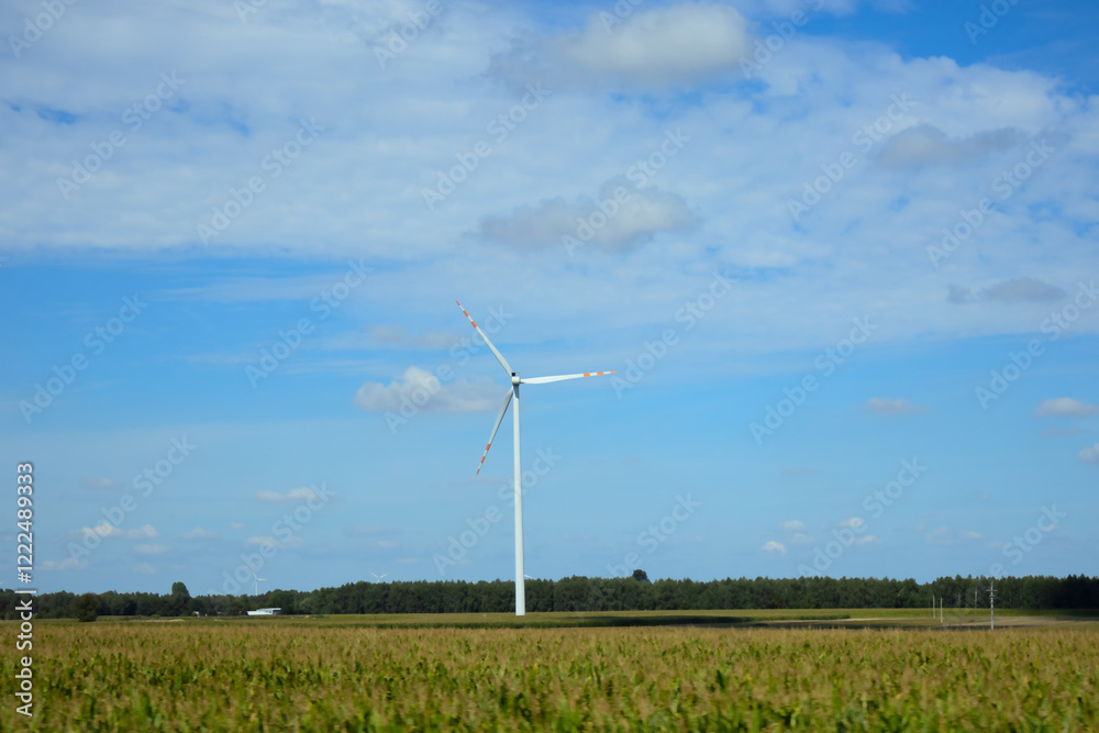 Wind turbine stands tall in a vast farmland under a clear blue sky Wind turbine stands tall in a vast farmland under a clear blue sky