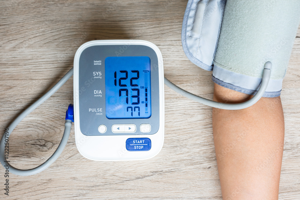 Man checking blood pressure and heart rate with digital sphygmomanometer And the results of measuring high blood pressure are dangerous to health. health concept Man checking blood pressure and heart rate with digital sphygmomanometer And the results of measuring high blood pressure are dangerous to health. health concept