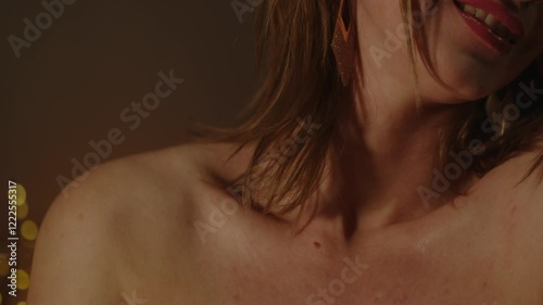 Tilt up of the beautiful body of an enticing woman smiling in slow motion
