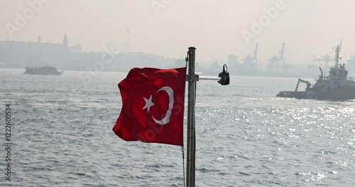 Captivating slow motion view of the Turkish flag on a ship cruising the Istanbul Bosphorus. Cinematic and high quality city silhouette