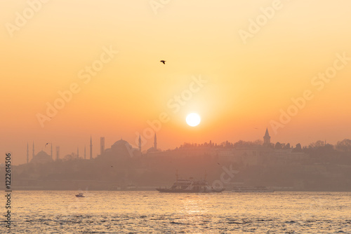 Canvas Print High resolution panoramic photograph capturing Istanbul's historic peninsula bathed in a crimson sunset glow