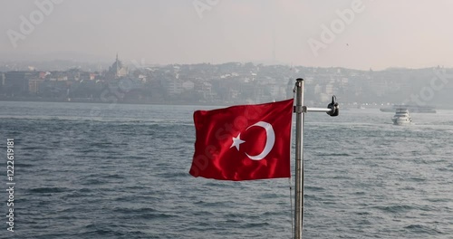 Captivating slow motion view of the Turkish flag on a ship cruising the Istanbul Bosphorus. Cinematic and high quality city silhouette.
