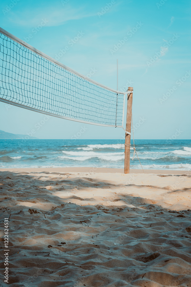 Beach volleyball court on sunny day with blue sky and ocean waves Beach volleyball court on sunny day with blue sky and ocean waves
