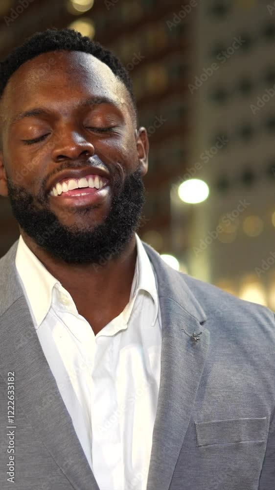 Confident businessman smiling in urban night setting
