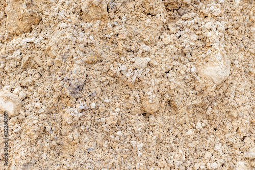 Close-up of sandy soil texture with pebbles