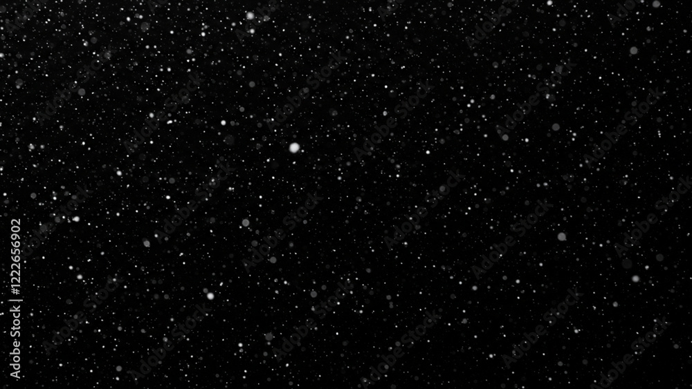 Obraz premium Isolated snowflakes drifting down on a black surface