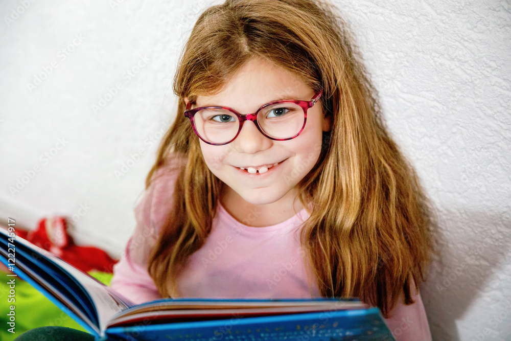 Little girl with eyeglasses reading book. Happy interested child learning. Little girl with eyeglasses reading book. Happy interested child learning.