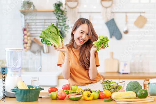 portrait young asian woman having fun in the kitchen,hand holding lettuce for cooking salad,healthy food,nutrition,vitamin,health
