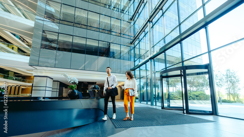 Quadro su tela Modern office lobby with colleagues walking together