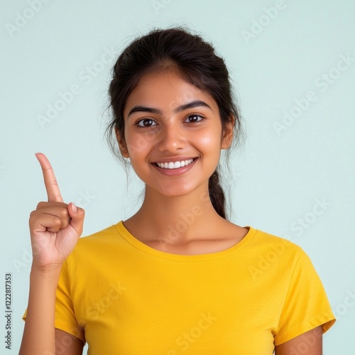 Indian woman wearing a yellow t-shirt happy background expression.