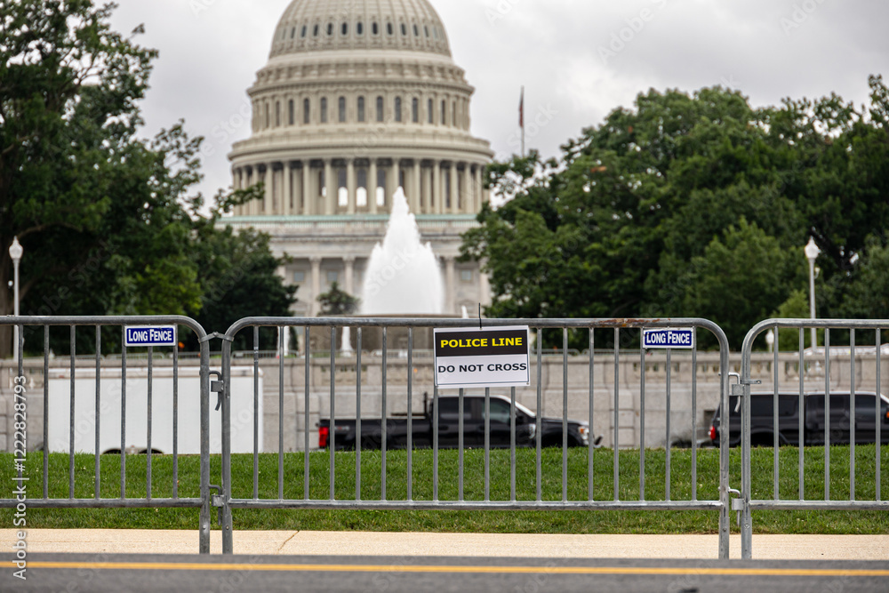 Police barricades with a view of the Capitol dome in the background, showcasing public safety and restricted access. Photo taken in Washington DC, USA.