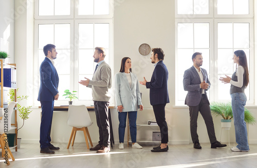 Fotografie Team of business people divides into groups for an office meeting, focusing on presentations, events, and partnership opportunities