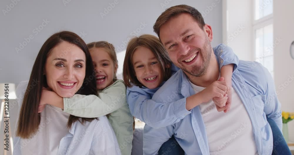 Portrait of a happy family with two kids at home, highlighting affection, parental love, and strong relationships. The bonding and cheerful expressions reflect a nurturing family environment. Portrait of a happy family with two kids at home, highlighting affection, parental love, and strong relationships. The bonding and cheerful expressions reflect a nurturing family environment.