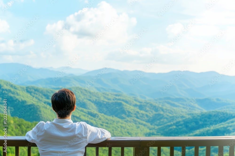 Fototapeta premium Smiling Woman Relaxing on Sunny Balcony with Scenic Mountain View