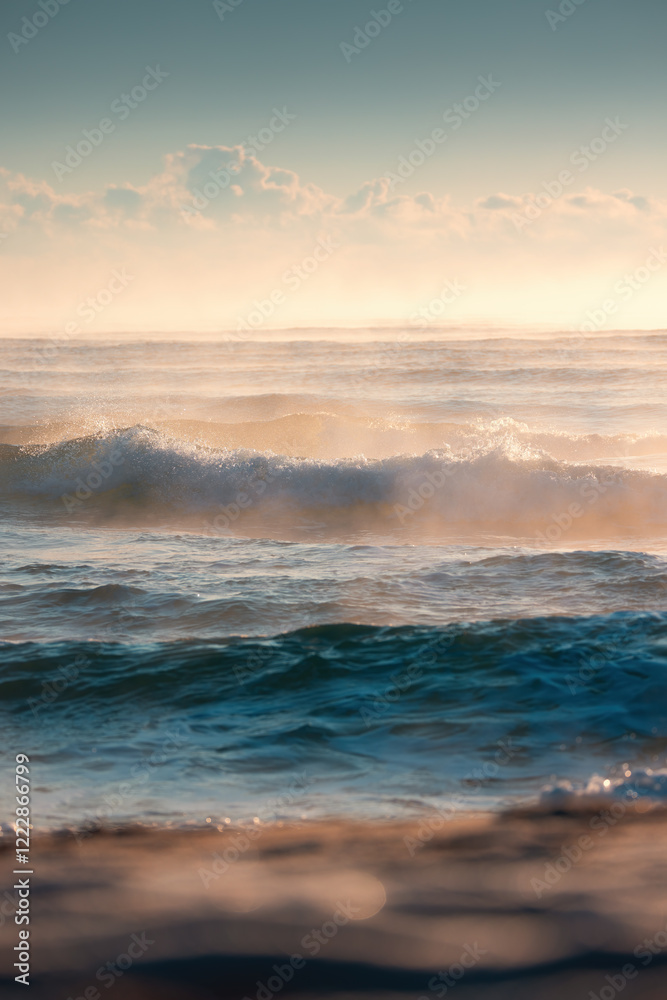 Fototapeta premium Beautiful Ocean Waves Captured During A Golden Sunset Over Serene Waters