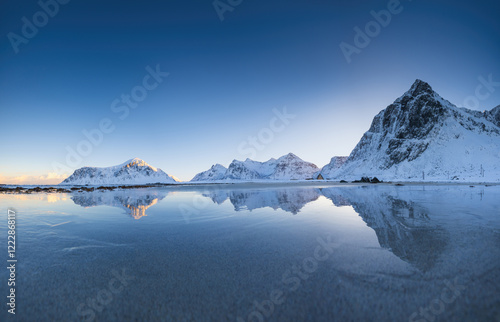 Winter scandinavian landscape view of Gimsoy beach with mountain peaks in snow Lofoten islands, Norway photo