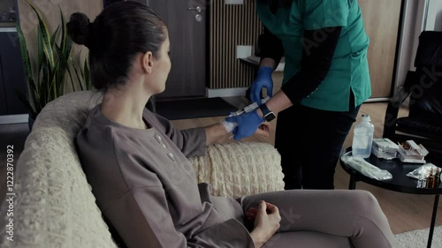 Nurse injecting patient with syringe at home