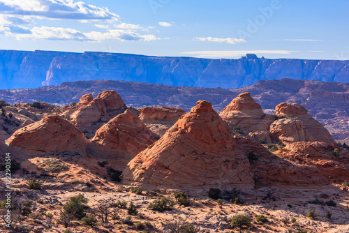 A mountain range with a few red rock formations photo