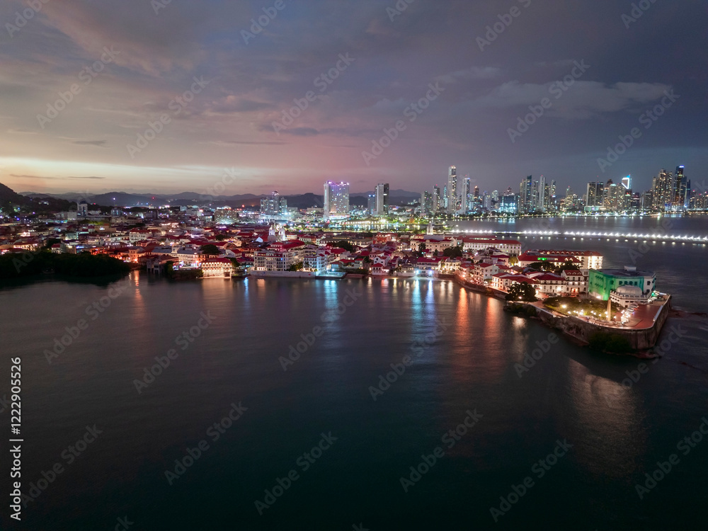 Fototapeta premium Panamá City, Panamá aerial view of the Casco Viejo historical French Square during dusk with city lights.
