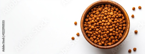 Dried cat food in a wooden bowl on a white background showcasing pet nutrition with ample copy space for branding or marketing text photo