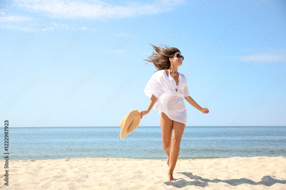 Young woman with beautiful body on sandy beach. Space for text Young woman with beautiful body on sandy beach. Space for text