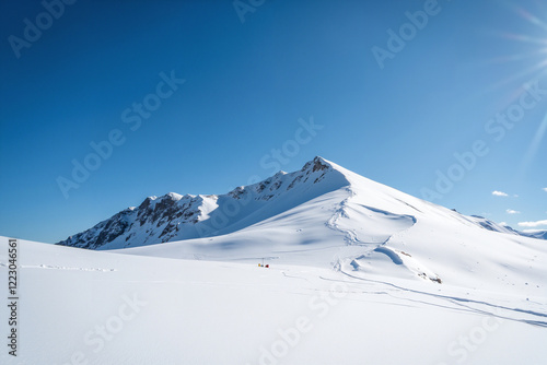 Snow-covered mountain peak under clear blue sky