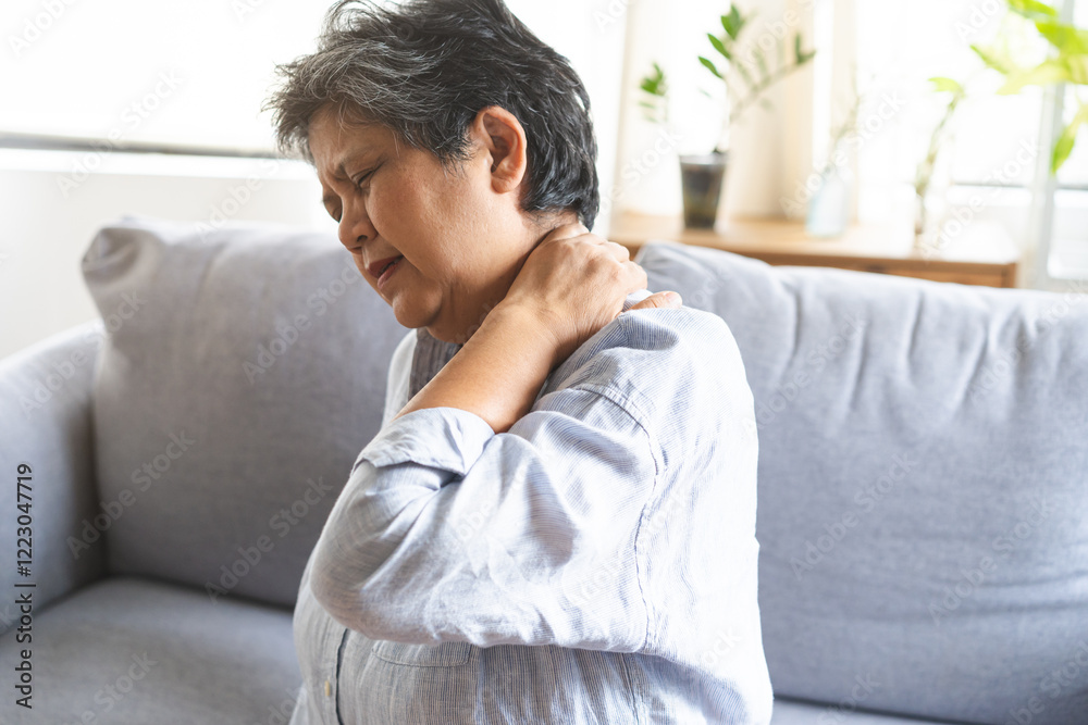 Pain body muscles stiff problem, suffer asian senior woman painful, older hand holding neck ache and aged holding massaging rubbing body, injury hurt,sore sitting on sofa at home. Health care concept. Pain body muscles stiff problem, suffer asian senior woman painful, older hand holding neck ache and aged holding massaging rubbing body, injury hurt,sore sitting on sofa at home. Health care concept.