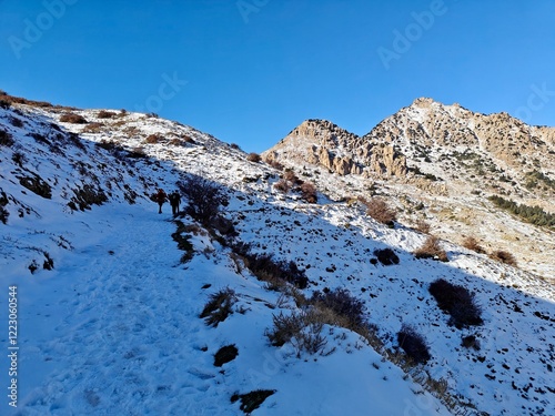 Hikers in the heights of Djurdjura, tell Atlas with snow-capped mountains. Bouira. Tizi ouzou. Bejaia. Algeria photo