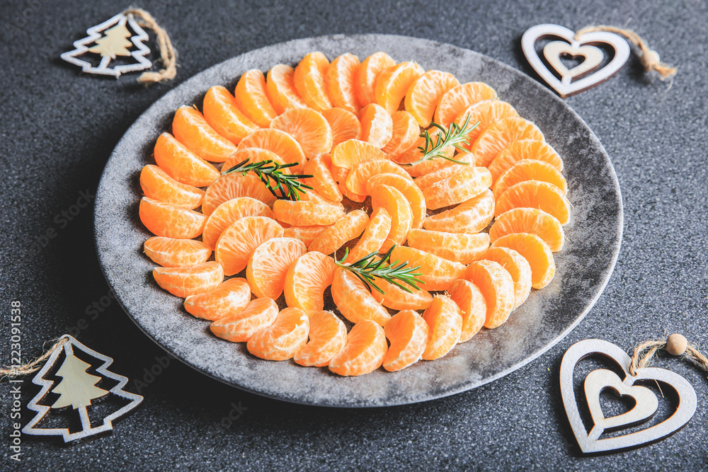 plate of clementine wedges arranged in a circle with christmas decoration