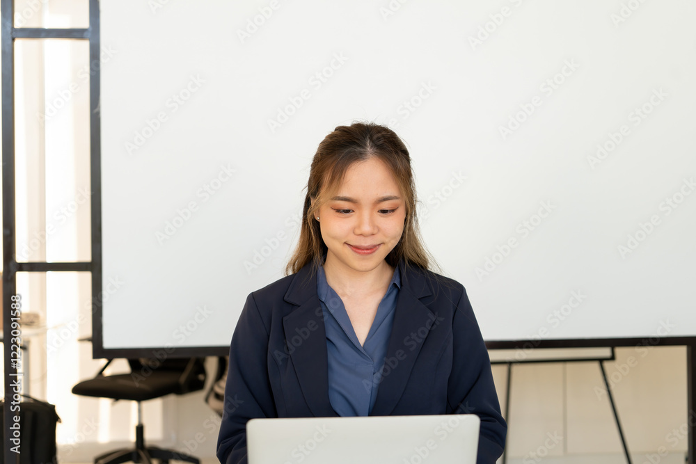 Businesswoman sitting at desk on couch in workplace or at home working on laptop and analyzing data on charts and graphs and writing on papers to make business plan and strategies for company. Businesswoman sitting at desk on couch in workplace or at home working on laptop and analyzing data on charts and graphs and writing on papers to make business plan and strategies for company.