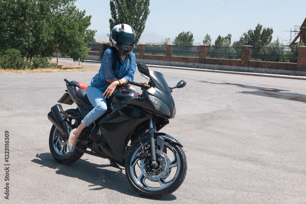 beautiful young girl with a black motorcycle beautiful young girl with a black motorcycle