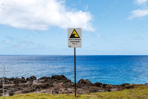 A tsunami warning sign with the Pacific Ocean in the background, Easter Island, Chile, Oceania photo