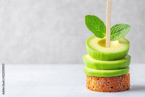 Fresh green apple slices stacked on a crumbly base with mint leaves, set against a light backdrop