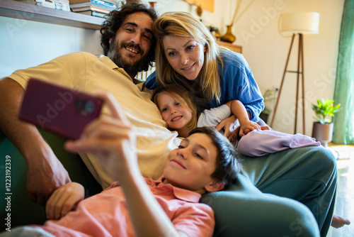 Selfie portrait of a happy family on the couch in cozy living room