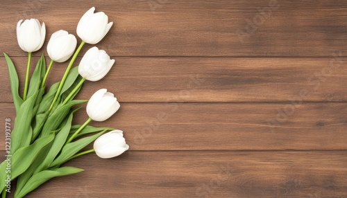 White tulips arranged on a wooden surface, creating a serene and elegant floral display