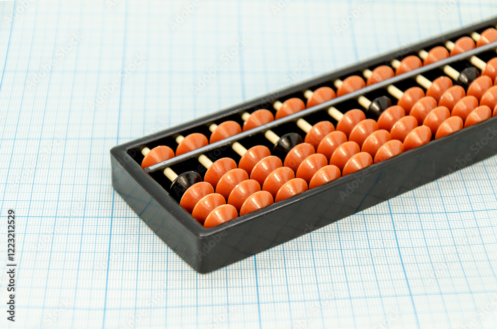 Abacus for mental arithmetic on light blue checkered background. space for text Abacus for mental arithmetic on light blue checkered background. space for text