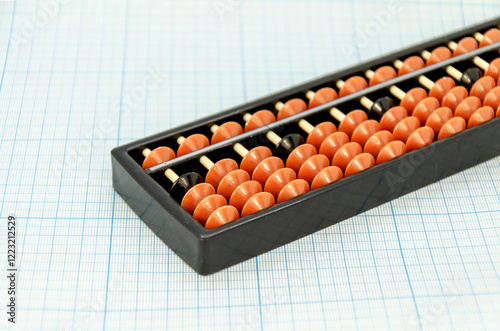 Abacus for mental arithmetic on light blue checkered background. space for text