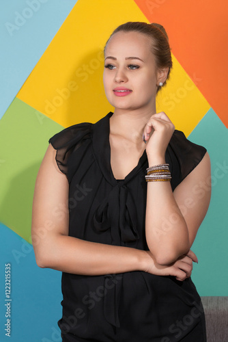 Obraz na płótnie Pensive woman in black dress and bracelet. w salonie