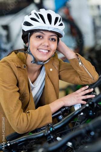 woman wearing helmet in a bike repair shop photo