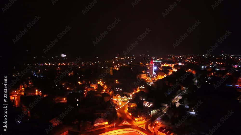 Drone shot of night view of cityscape with fireworks bursting in sky. Drone shot of night view of cityscape with fireworks bursting in sky.