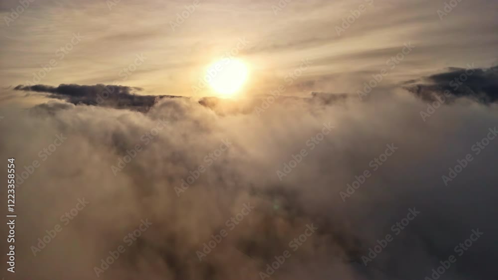 Tilt down a drone through the clouds in the sky with sunset Tilt down a drone through the clouds in the sky with sunset