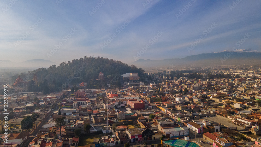 Aerial photography of the Nevado de Toluca landscape at dawn, with snow, clouds and a sky with ochre and red colors can be seen, in addition to a view of the magical town of Metepec. Aerial photography of the Nevado de Toluca landscape at dawn, with snow, clouds and a sky with ochre and red colors can be seen, in addition to a view of the magical town of Metepec.