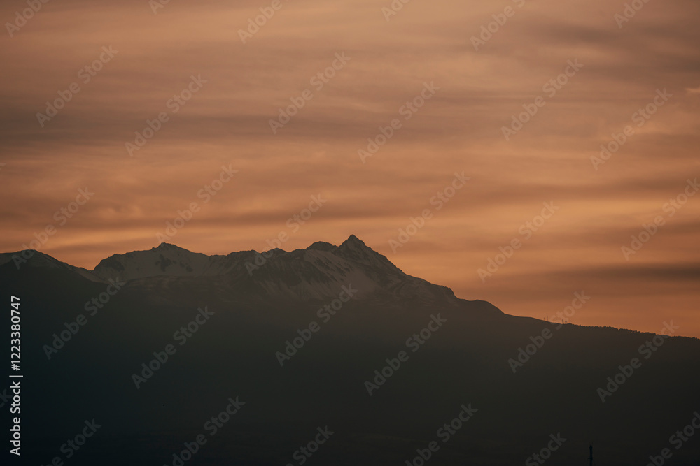 Landscape of the Nevado de Toluca at sunset, with snow, clouds and a sky with ochre and red colors can be seen. Landscape of the Nevado de Toluca at sunset, with snow, clouds and a sky with ochre and red colors can be seen.