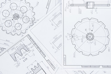 paper engineering drawings of industrial parts and mechanisms	