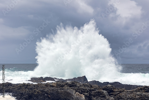Large Atlantic Ocean waves crash onto rocky shores in Cape Town, South Africa