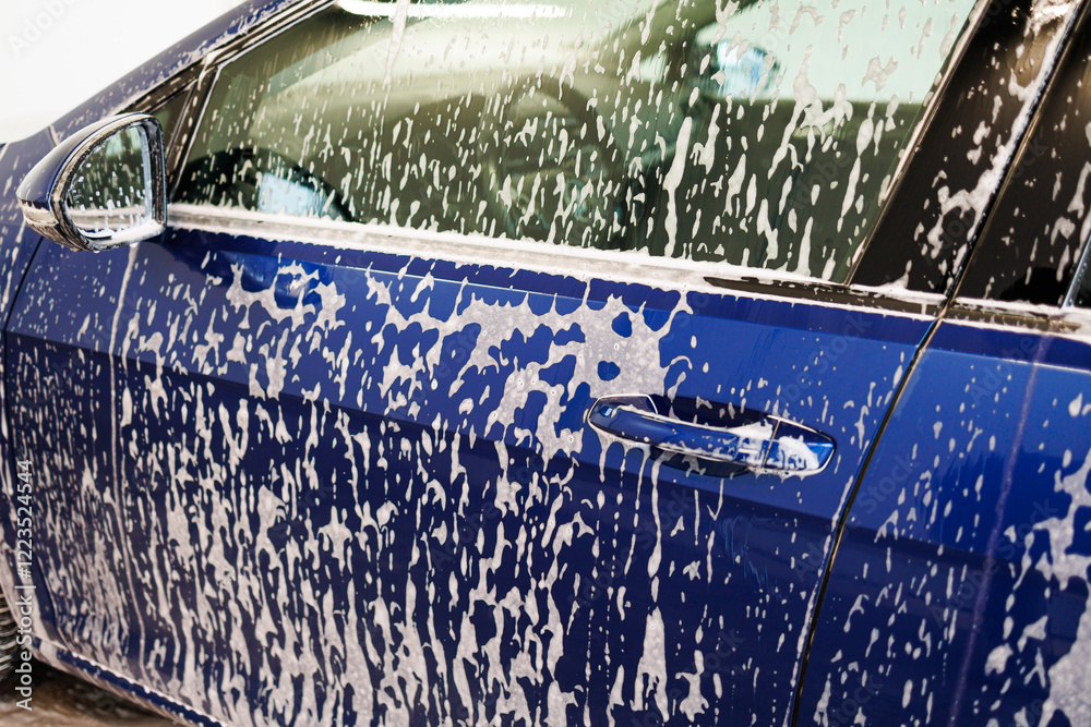 Close-up photo. Car parts with thick foam. Chemicals for washing dirty vehicles.
