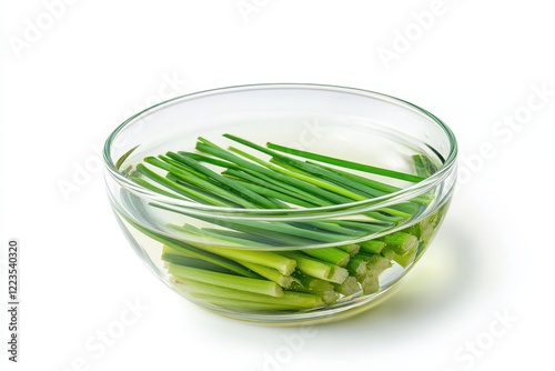 A beneficial extract or infusion of lili chai lemongrass or green tea for weight loss and health displayed in a glass bowl on a white background