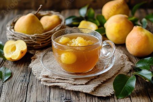 Tea cup with homemade quince jam on aged wood Fresh fruits and quince leaves in the backdrop Horizontal image photo