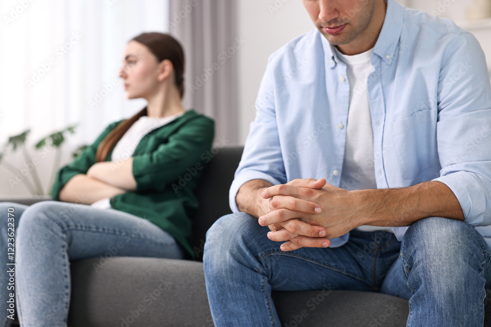 Offended couple ignoring each other at home, selective focus Offended couple ignoring each other at home, selective focus